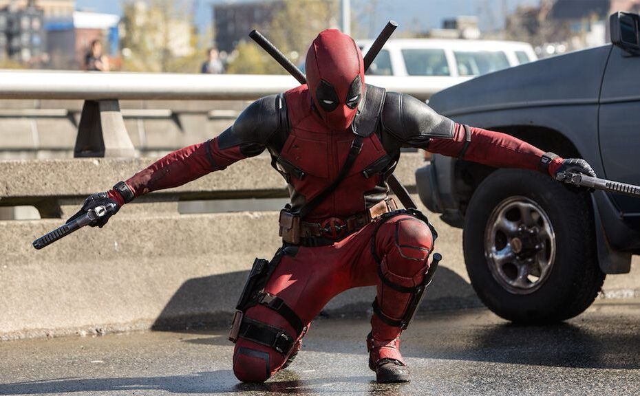 Deadpool armed with weapons in street