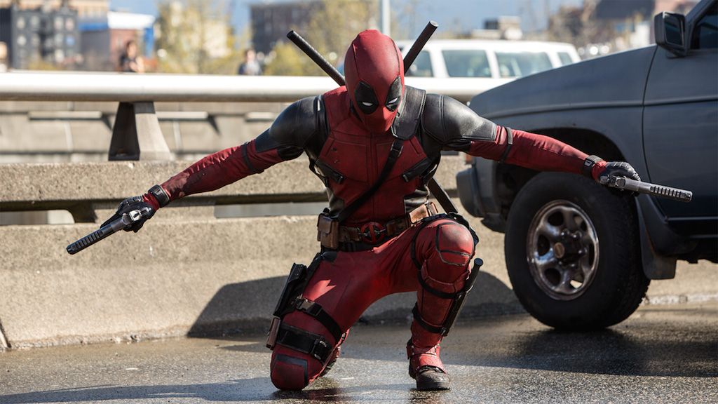 Deadpool armed with weapons in street