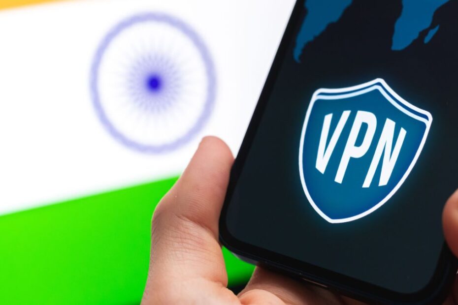 Hand holding a smartphone with VPN logo on screen and the Indian flag on the background