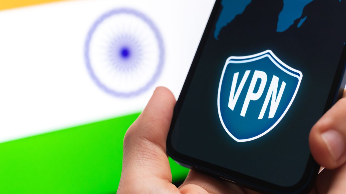 Hand holding a smartphone with VPN logo on screen and the Indian flag on the background
