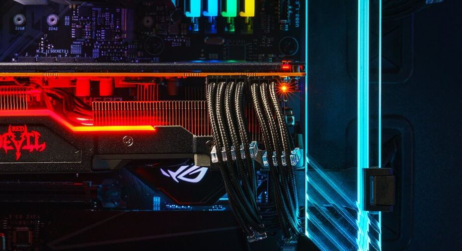 inside a PC with colored lighting, on the right is a blue glass gpu support bracket