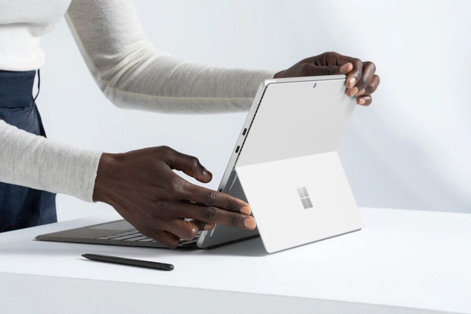 Surface Pro 8 on a white surface, being used by someone