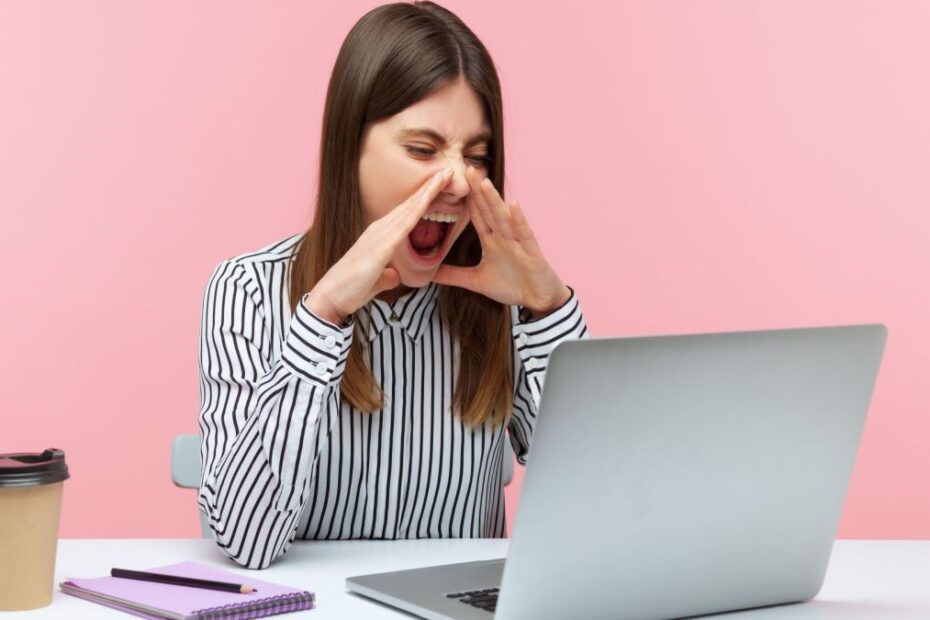 Frustrated person shouting at laptop